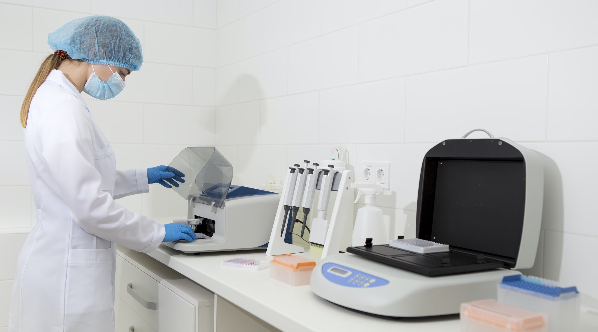 Young scientist working in biological laboratory with sample